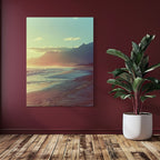 Golden sunrise casting warm tones over a quiet beach with ocean waves and distant mountain silhouettes.