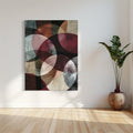 Abstract art with overlapping dark red and earthy-toned circles on a textured background
